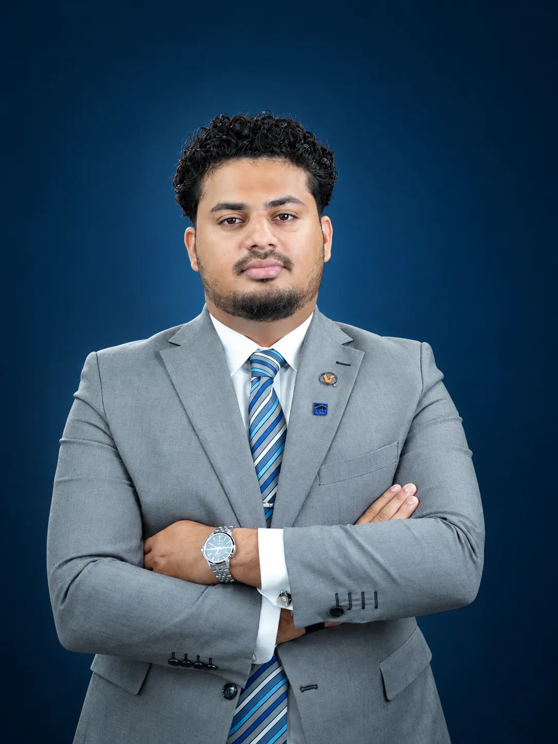 Veer & Sant property consultant in a grey suit, Dubai office team